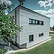 Sidovy av en modern villa med utsikt över Siding.X-fasaden.