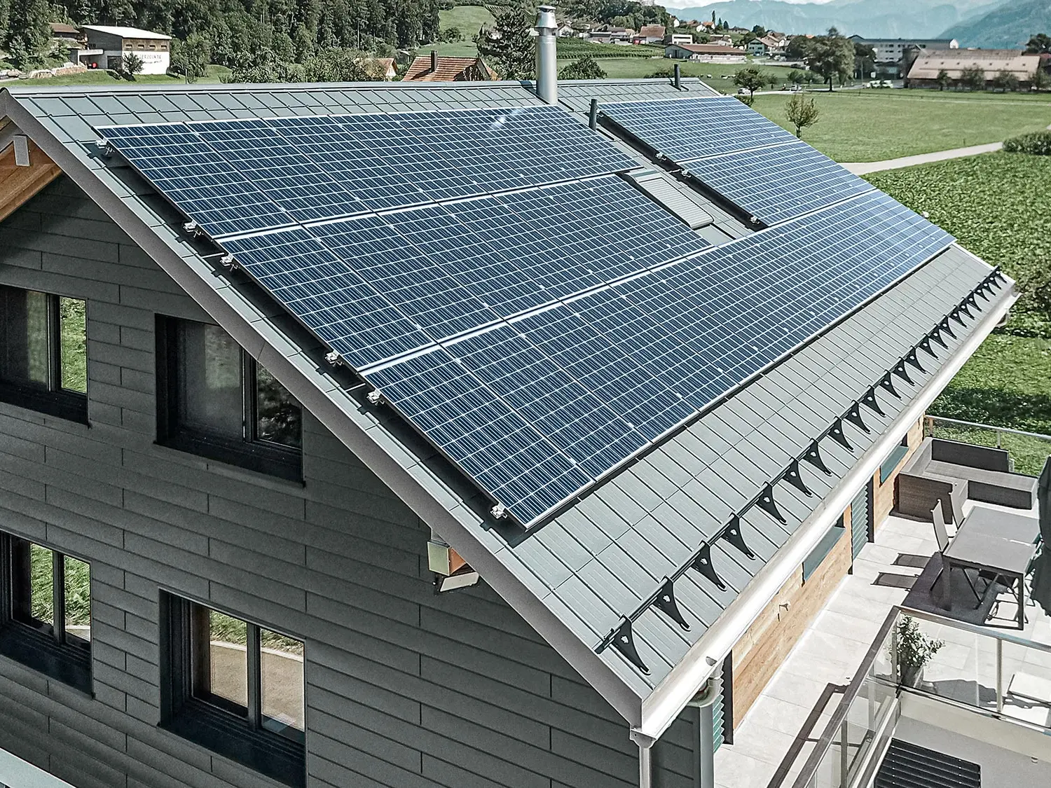 Fotovoltaikssystem monterat på PREFA-tak med solpanelhållare och profilskena för säkert fäste.