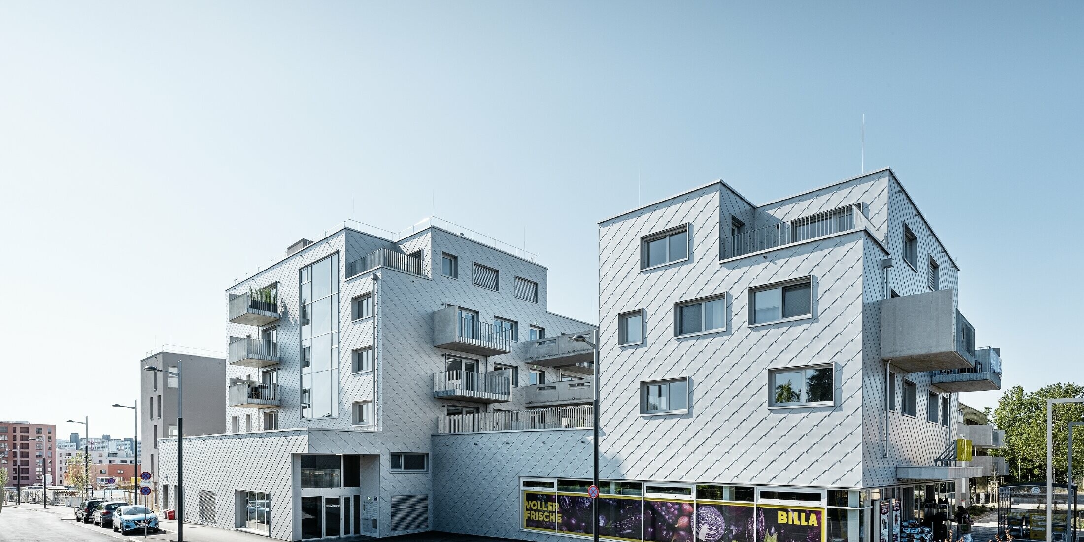 Bostadshus med flackt tak och rombbeklädnad på fasaden med PREFA väggromb 44 × 44 i silvermetallic